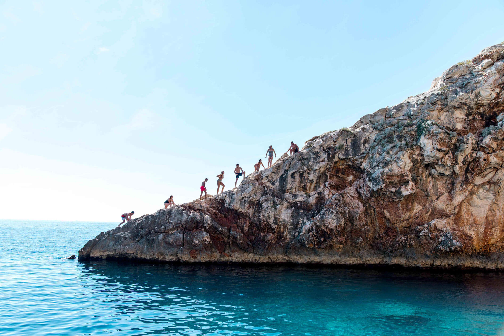 Jumping into the sea at Red Rocks near Hvar Island Croatia